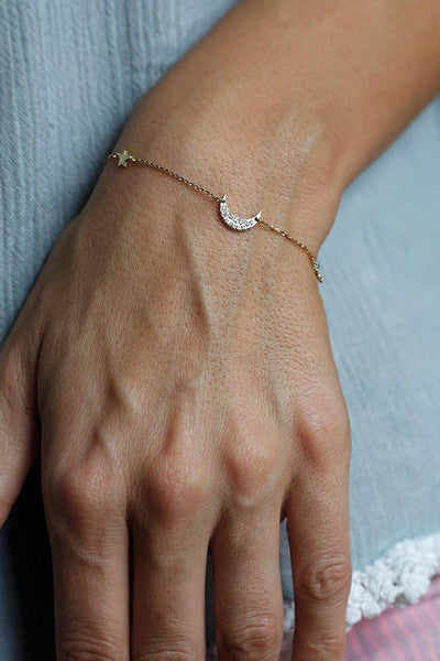 Solid gold moon and stars bracelet with round white diamonds