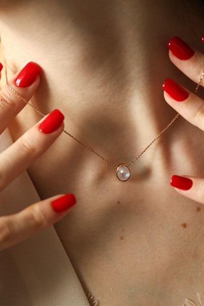 Gold chain with white oval moonstone