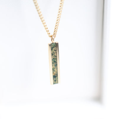 Men's bar necklace featuring a sleek 14K gold pendant with a moss agate inlay, showcasing natural green and earthy patterns on a sturdy chain.