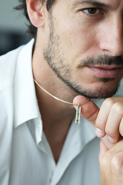 Men's bar necklace featuring a sleek 14K gold pendant with a moss agate inlay, showcasing natural green and earthy patterns on a sturdy chain.