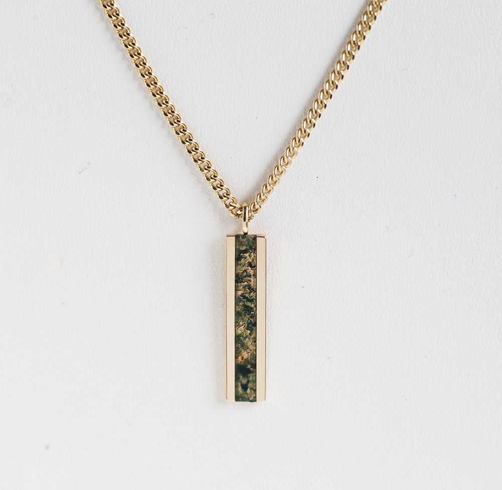 Men's bar necklace featuring a sleek 14K gold pendant with a moss agate inlay, showcasing natural green and earthy patterns on a sturdy chain.