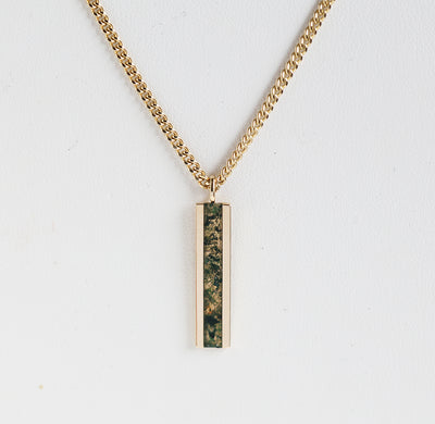 Men's bar necklace featuring a sleek 14K gold pendant with a moss agate inlay, showcasing natural green and earthy patterns on a sturdy chain.