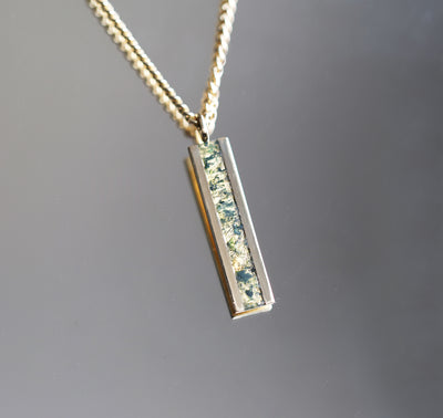 Men's bar necklace featuring a sleek 14K gold pendant with a moss agate inlay, showcasing natural green and earthy patterns on a sturdy chain.