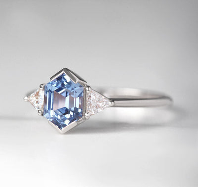 Hexagon-shaped blue sapphire ring with white side diamonds