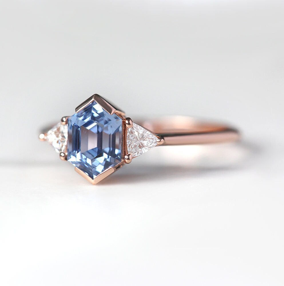 Hexagon-shaped blue sapphire ring with white side diamonds