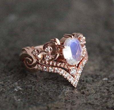 Vintage ring featuring oval-cut Moonstone and white Diamonds in 14k rose gold.