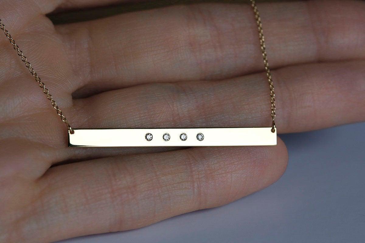 Gold bar chain necklace with four round diamonds