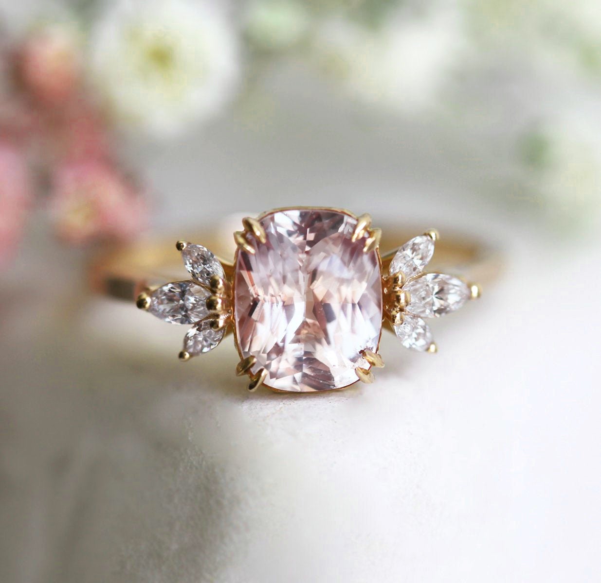Cushion-cut peach sapphire cluster ring with diamonds