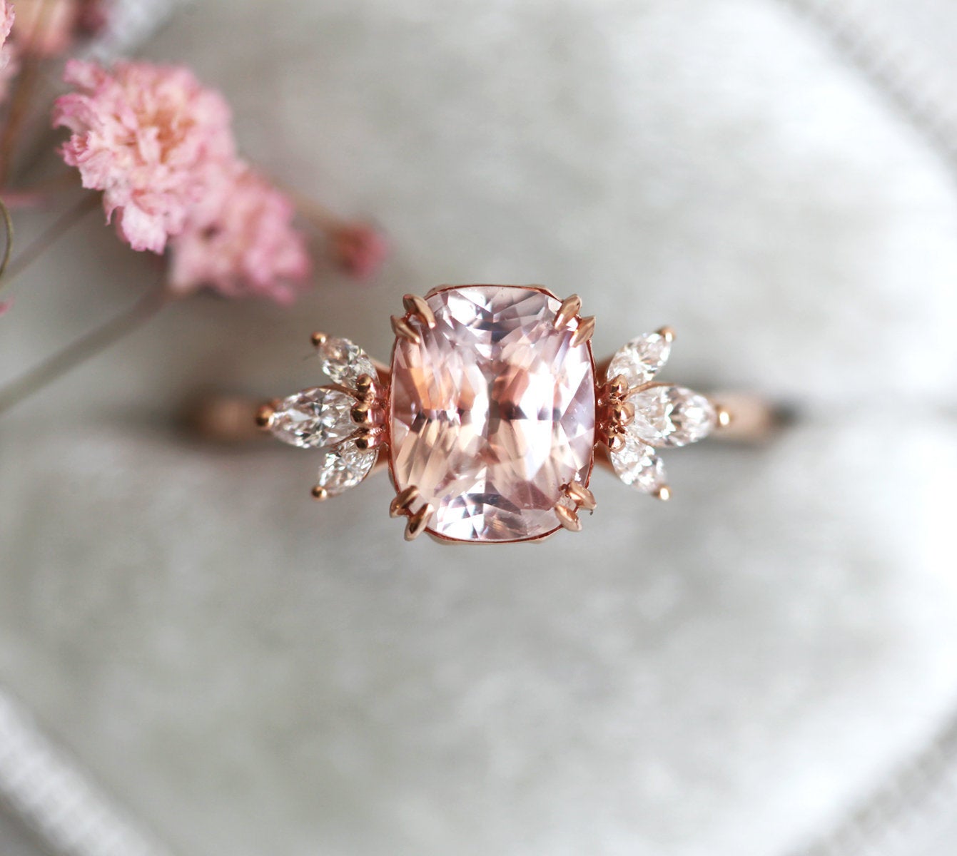 Cushion-cut peach sapphire cluster ring with diamonds