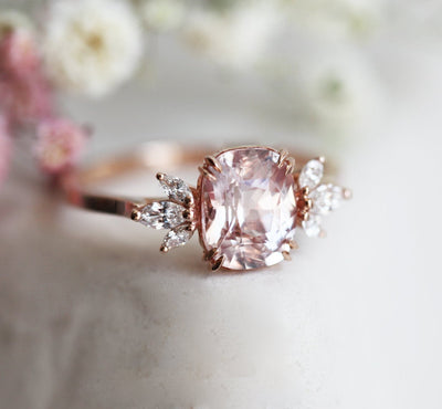 Cushion-cut peach sapphire cluster ring with diamonds