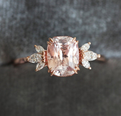 Cushion-cut peach sapphire cluster ring with diamonds