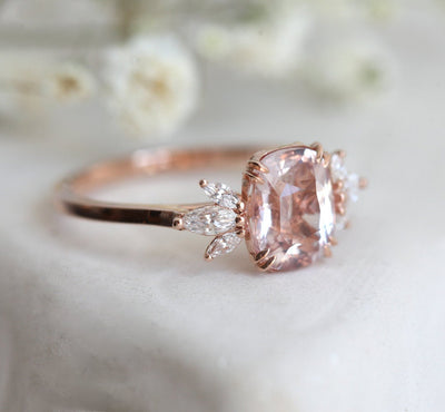 Cushion-cut peach sapphire cluster ring with diamonds