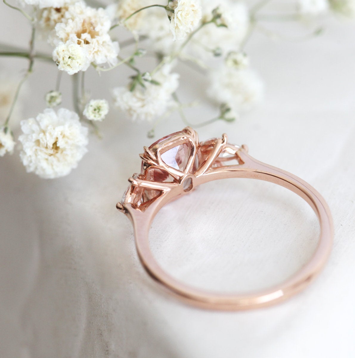 Cushion-cut peach sapphire cluster ring with diamonds