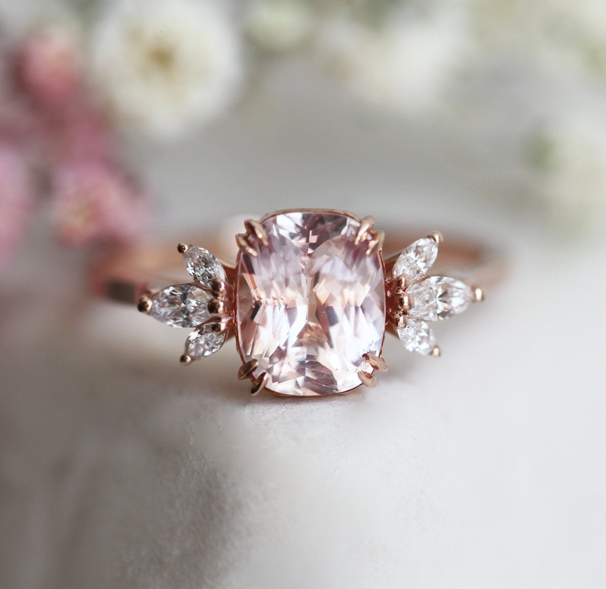 Cushion-cut peach sapphire cluster ring with diamonds