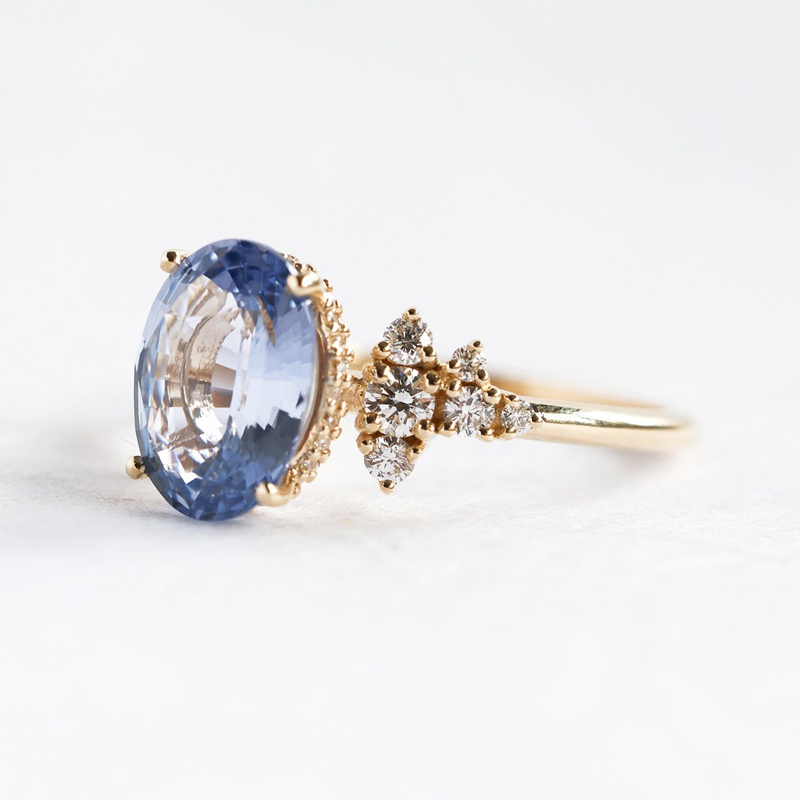 Oval-shaped blue sapphire ring with side diamonds