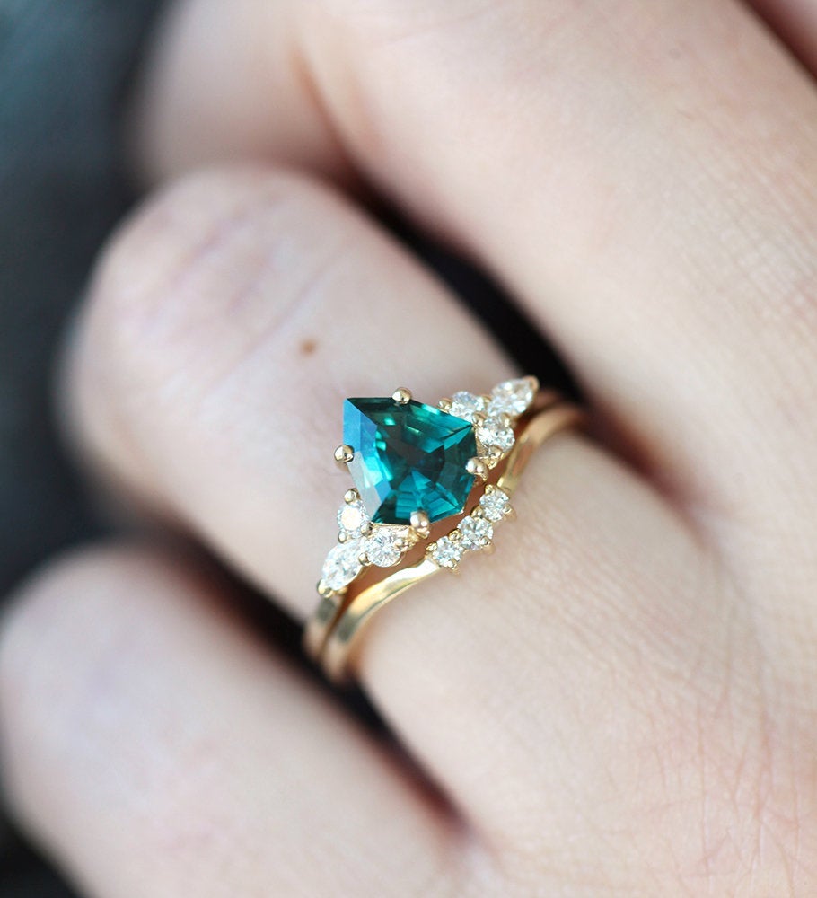 Pear-shaped blue green sapphire cluster ring with diamonds