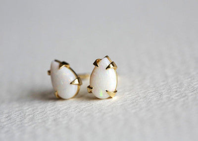 Pear-shaped white opal stud gold earrings