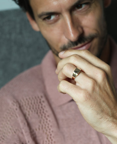 A man with a mustache wearing the Orson Crushed Signet Ring in gold.