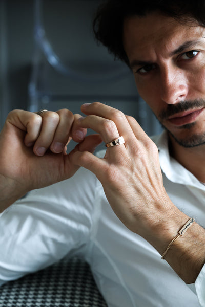 A man wearing a gold Orson signet ring, showcasing elegant design.