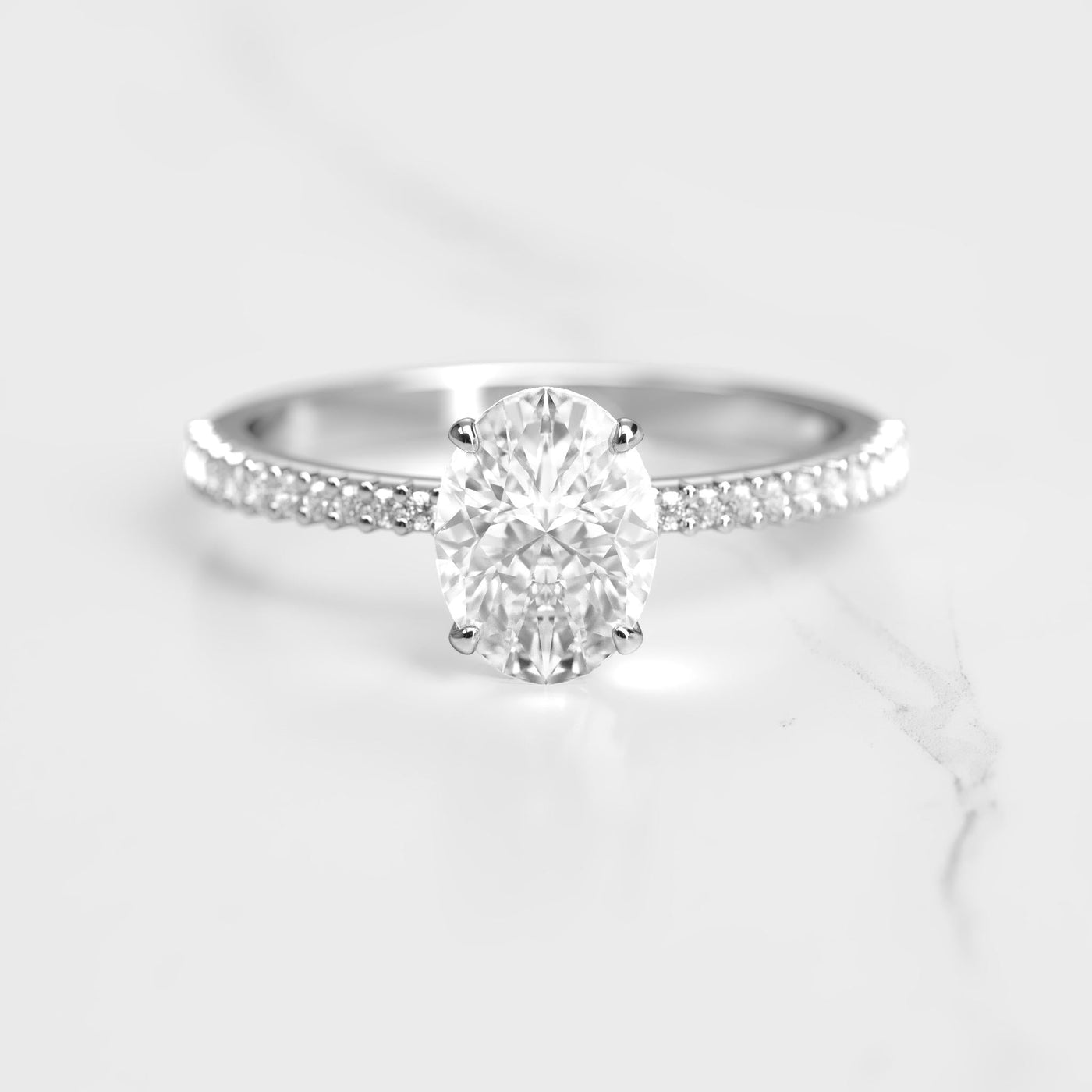 Oval half pave tapered moissanite ring