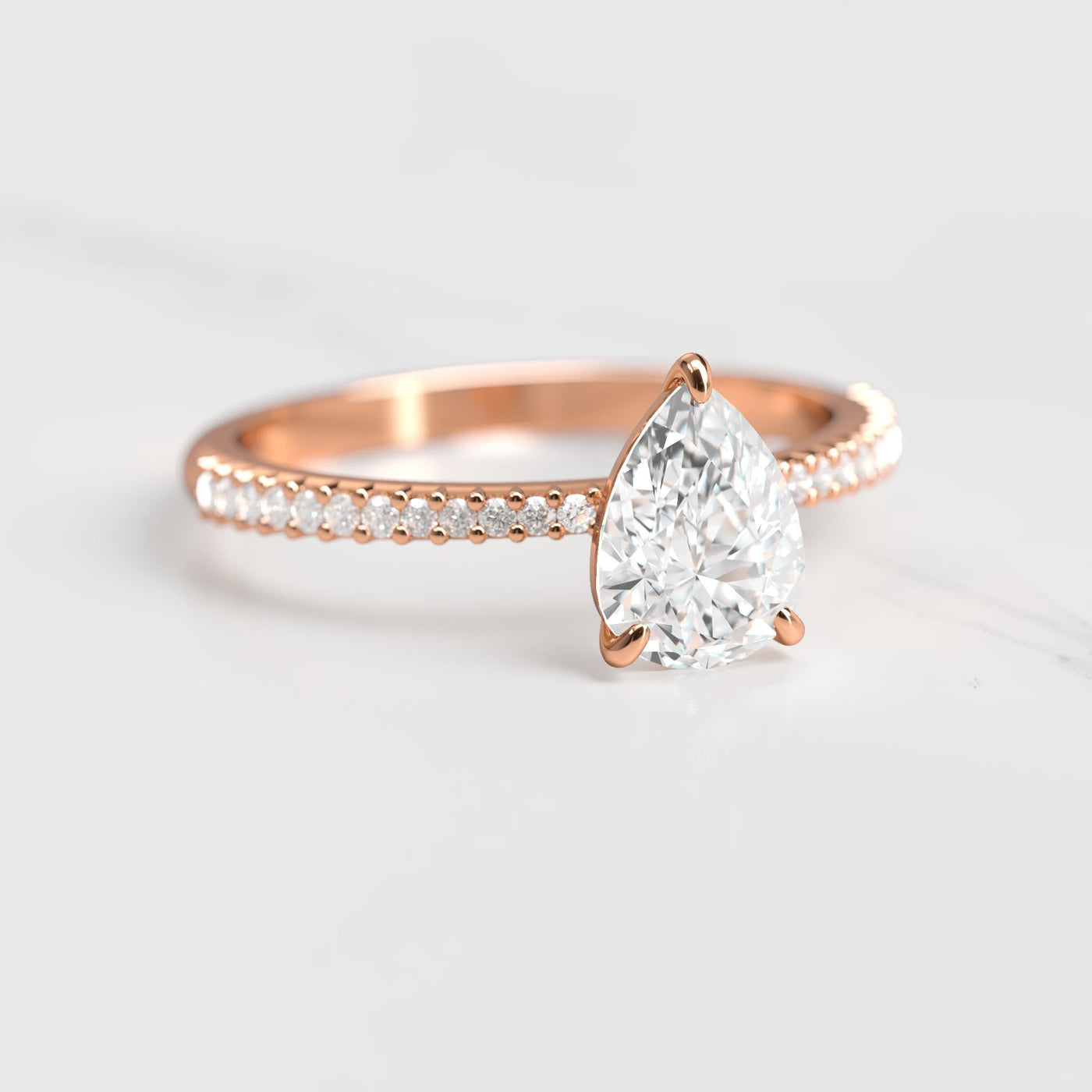 Pear-shaped half pave tapered diamond ring