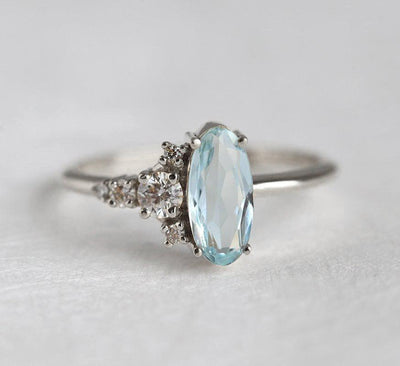 Oval Aquamarine White Gold Ring with Asymmetrical Side Cluster Diamonds
