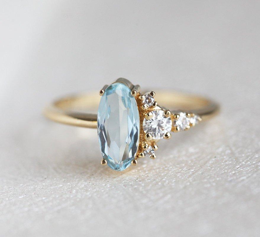 Oval Aquamarine Yellow Gold Ring with Asymmetrical Side Cluster Diamonds