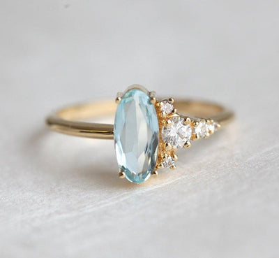 Oval Aquamarine Yellow Gold Ring with Asymmetrical Side Cluster Diamonds