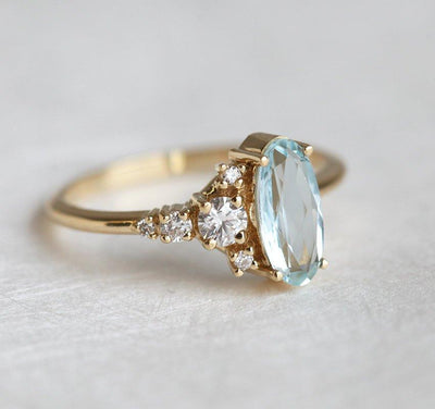 Oval Aquamarine Yellow Gold Ring with Asymmetrical Side Cluster Diamonds