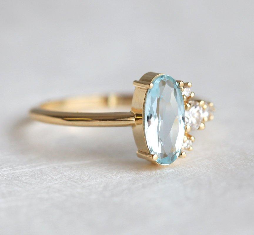Oval Aquamarine Yellow Gold Ring with Asymmetrical Side Cluster Diamonds