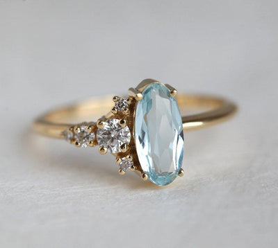 Oval Aquamarine Yellow Gold Ring with Asymmetrical Side Cluster Diamonds