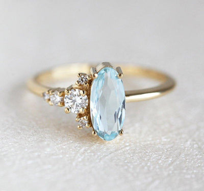 Oval Aquamarine Yellow Gold Ring with Asymmetrical Side Cluster Diamonds