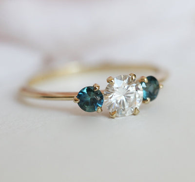 Round moissanite and teal sapphire engagement ring