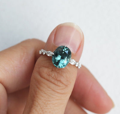 Vintage oval-shaped teal sapphire with side diamonds