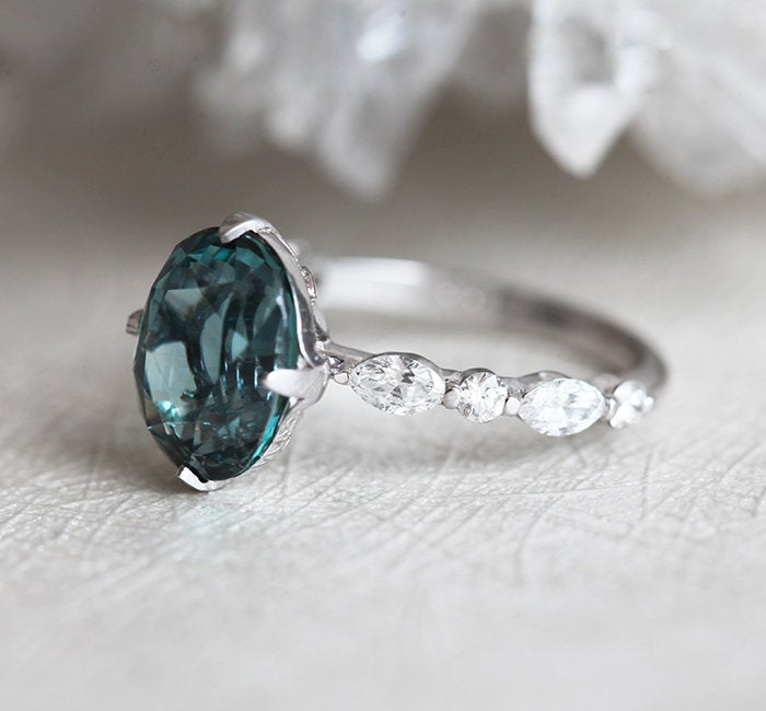 Vintage oval-shaped teal sapphire with side diamonds