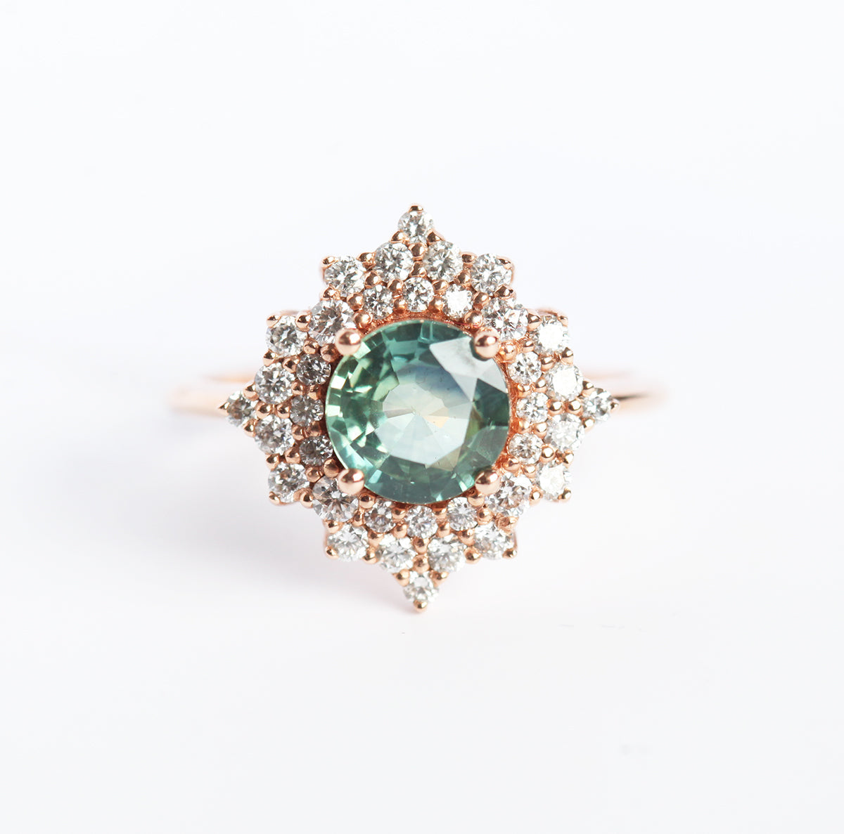 Round teal sapphire ring with diamond halo