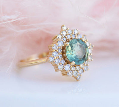 Round teal sapphire ring with diamond halo