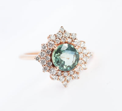 Round teal sapphire ring with diamond halo