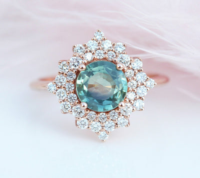 Round teal sapphire ring with diamond halo