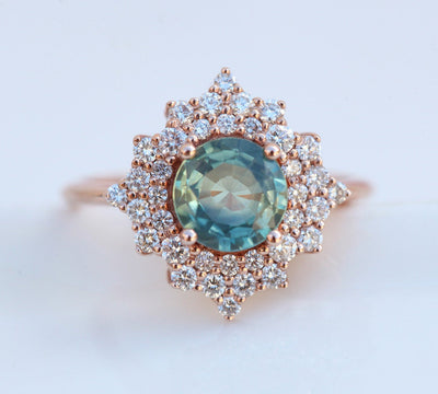 Round teal sapphire ring with diamond halo