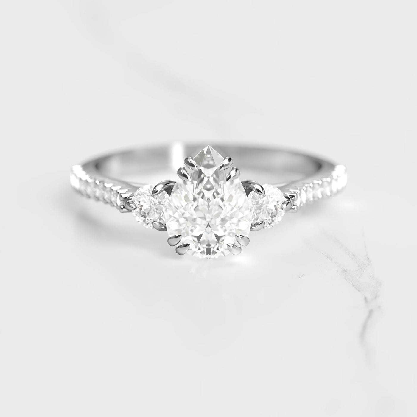 Pear-shaped half pave diamond ring with accent stones