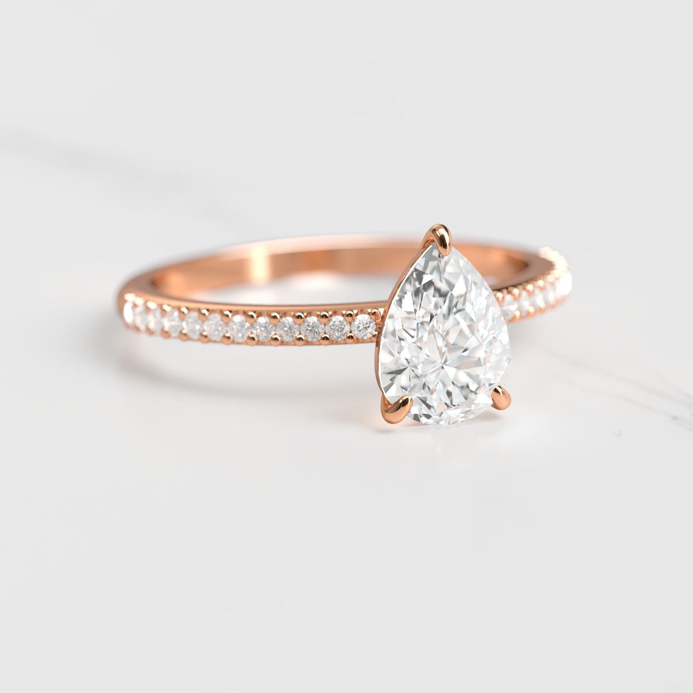 Pear-shaped half pave moissanite ring