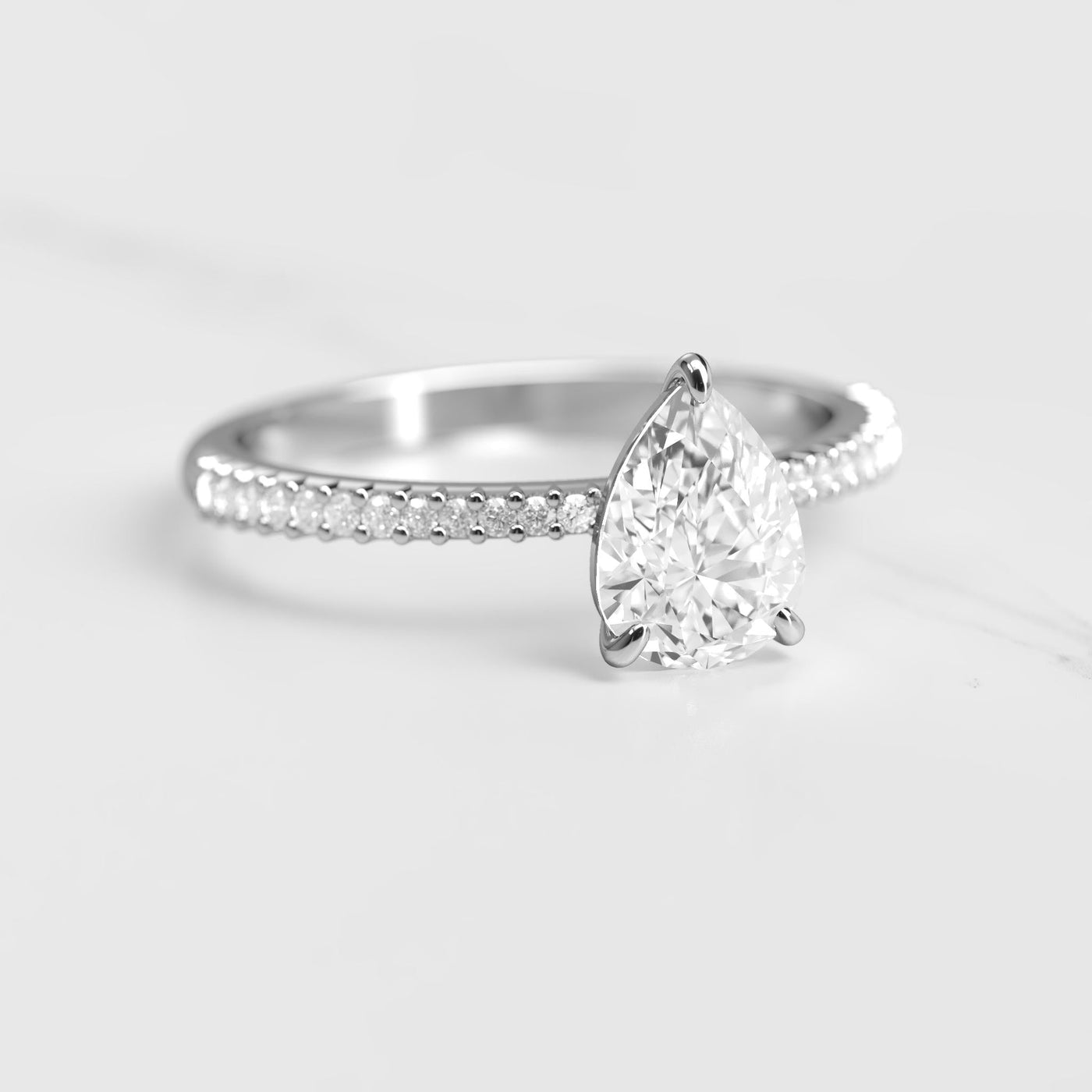 Pear-shaped half pave tapered moissanite ring