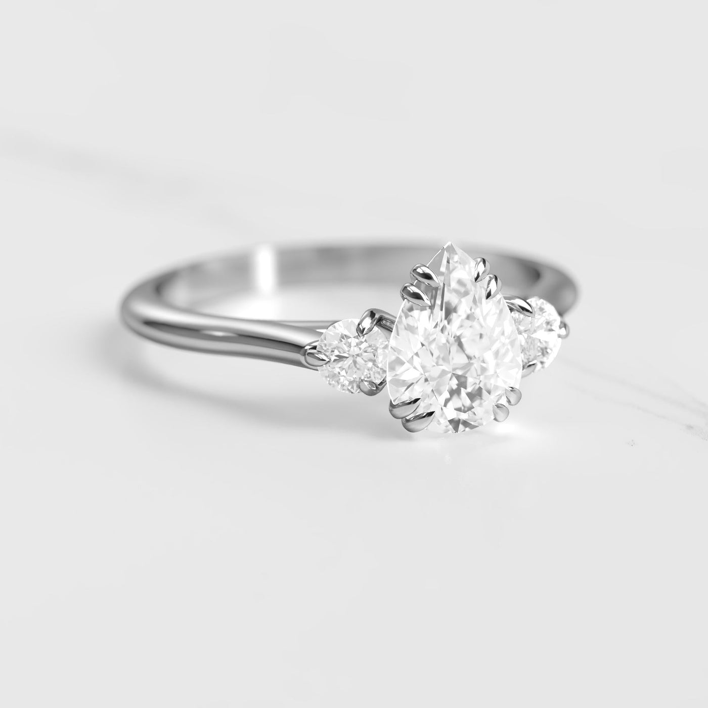 3-Stone pear-shaped white moissanite ring