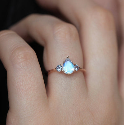 Pear-shaped white moonstone ring with side sapphires