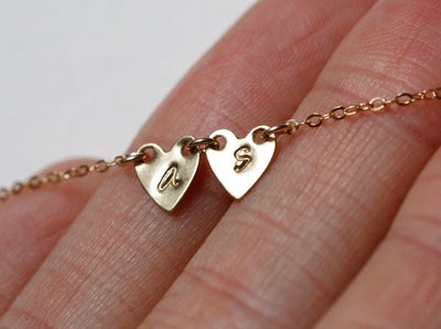 Gold necklace with gold hearts and personalized sideways initials