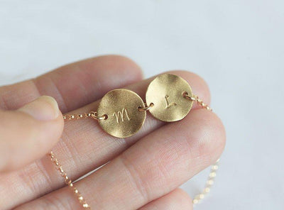 Gold necklace with gold discs and personalized initials