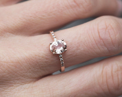 Oval-shaped peach sapphire ring with white diamonds