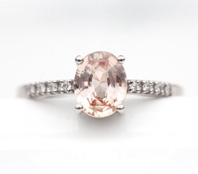 Oval-shaped peach sapphire ring with white diamonds