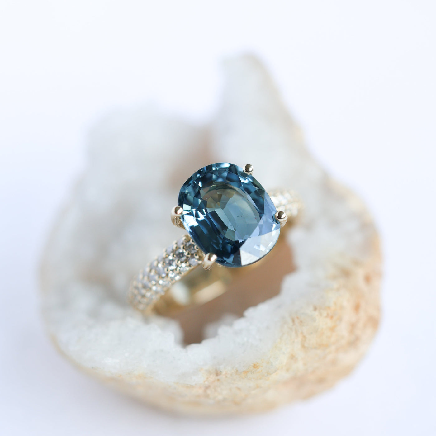 Oval-shaped blue sapphire ring with diamonds